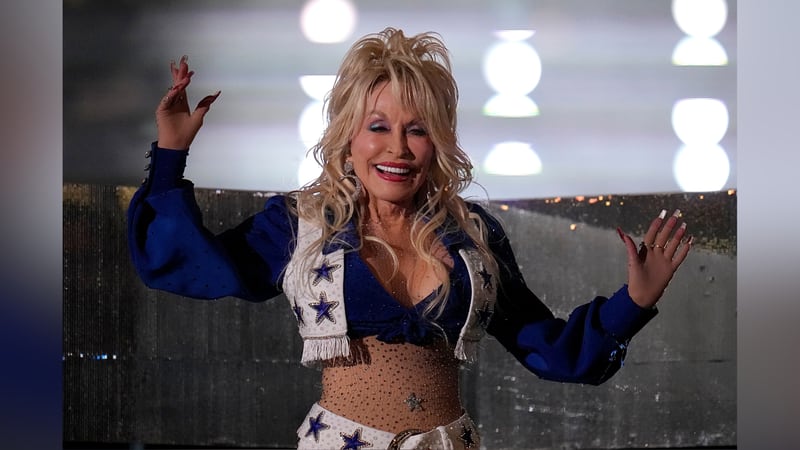 Dolly Parton performs during halftime of an NFL football game between the Dallas Cowboys and...