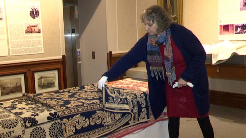 Executive director Toni Engleman shows a few of the coveted Tyler coverlets on display at the...
