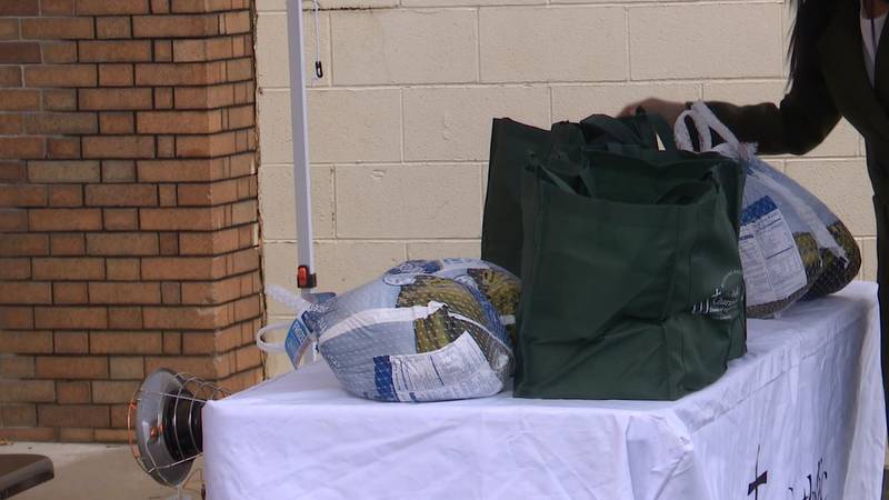 Bags with turkeys, other Thanksgiving food, are lined up Wednesday morning in Ogdensburg for...
