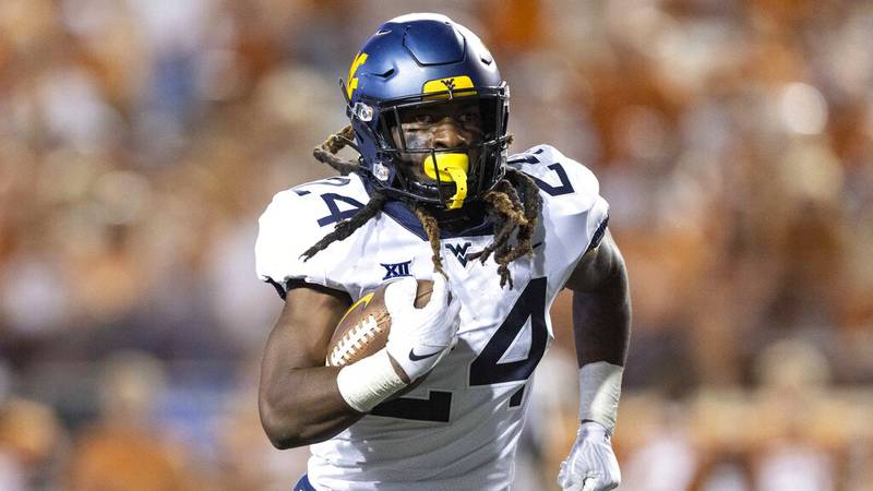 West Virginia running back Tony Mathis Jr. (24) looks for more yards against Texas during the...