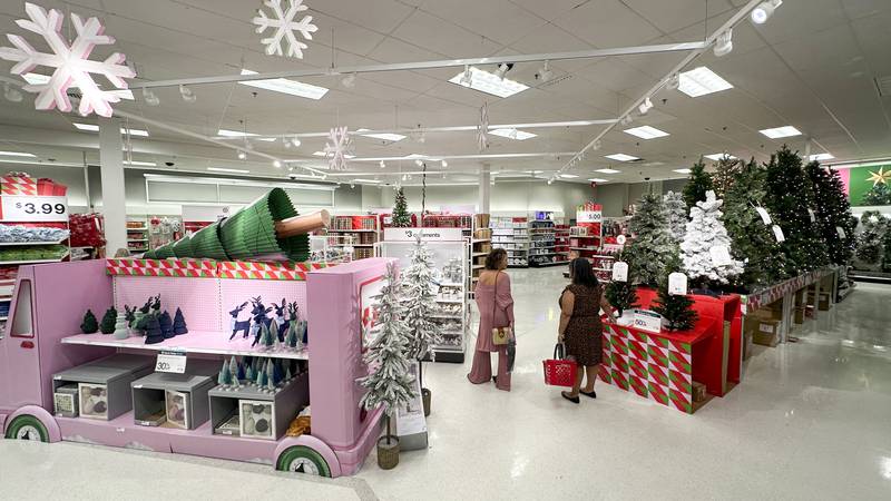 Shoppers look over holiday merchandise on display at a Target store Wednesday, Nov. 15, 2023,...